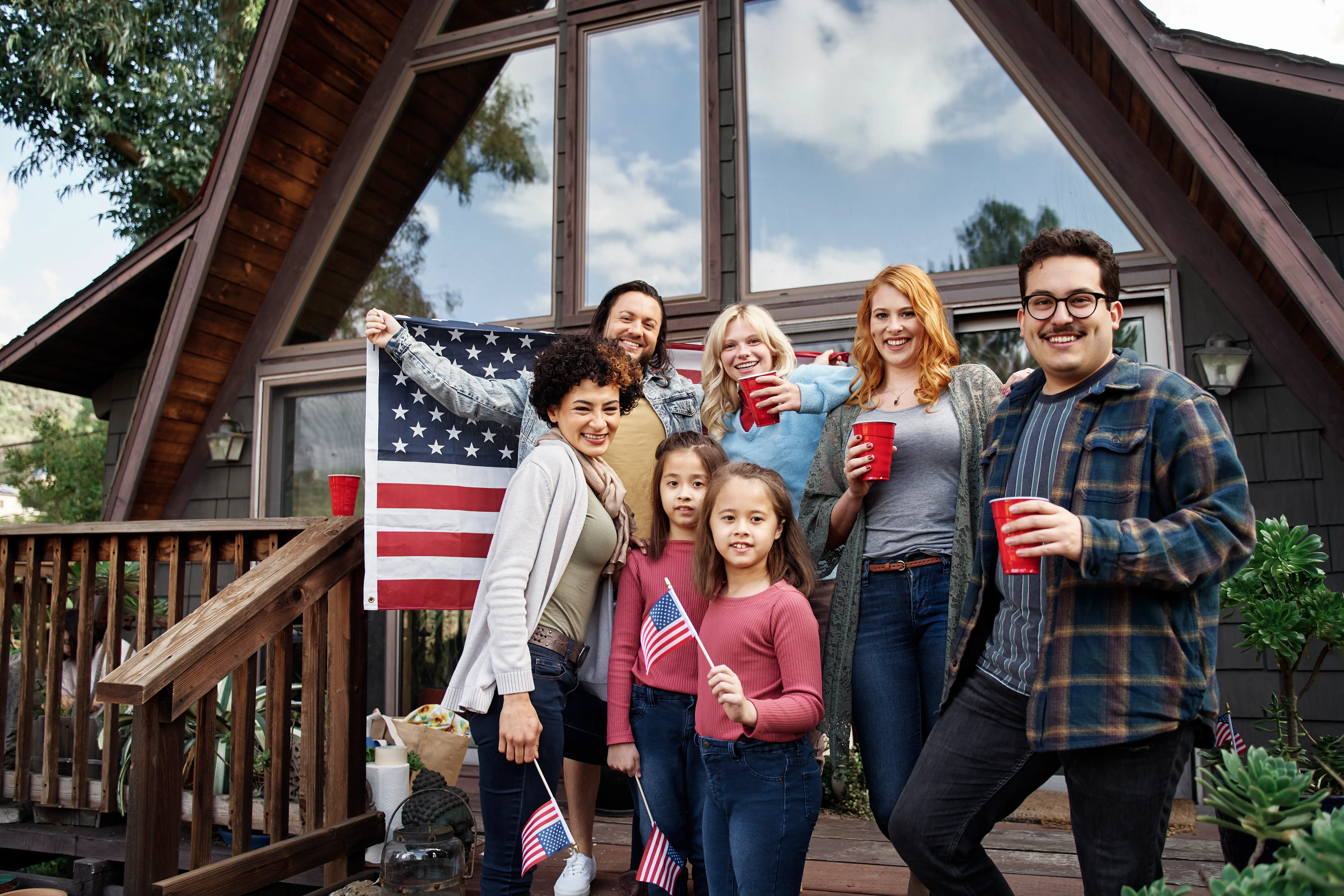 American family and friends celebrating together outside their home